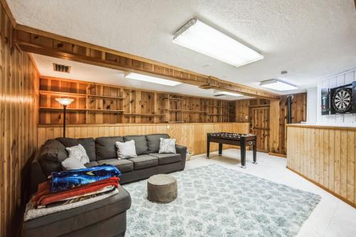 a living room with a couch and a table at Famed Plaza Oasis 1 mile away, King Bed, Office, Foosball in Santa Fe