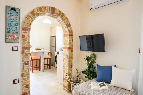 a living room with a couch and an archway at Olive Studios Karpathos Studio #1 in Karpathos Town