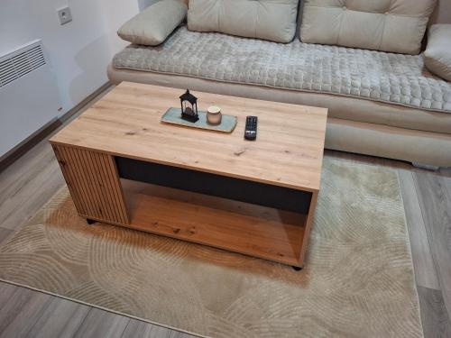 a wooden coffee table in front of a couch at Apartmani Marjanovic in Jagodina