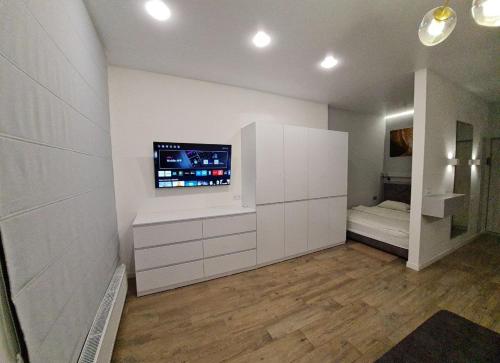 a living room with a flat screen tv on a wall at ApartPlus - Затишні апартаменти in Dnipro