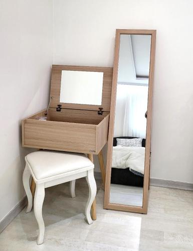 a dressing table with a mirror and a stool at Wonju Aunt Home in Wonju