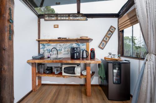 a kitchen with a table and a sink in a room at Riviera Santo Antônio in Florianópolis