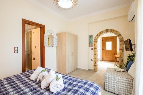 a bedroom with a bed with towels on it at Olive Studios Karpathos Studio #1 in Karpathos Town