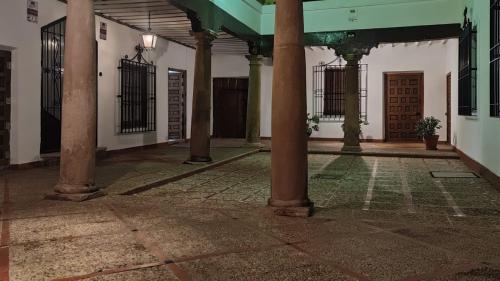 an empty courtyard with columns and gates in a building at Morada El Rincón in Villanueva de los Infantes