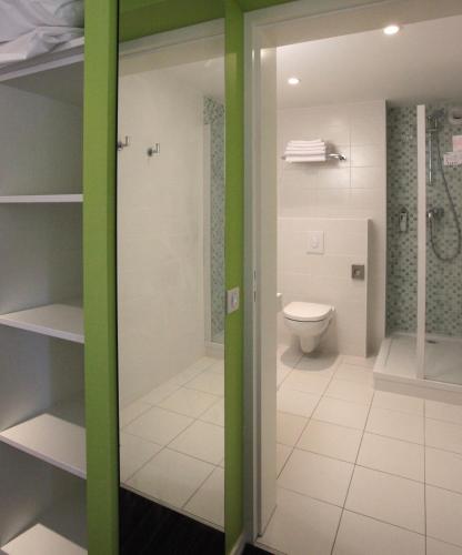 a bathroom with a shower and a toilet at ibis Styles Quiberon Centre in Quiberon