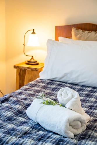 a pile of towels sitting on top of a bed at Olive Studios Karpathos Studio #1 in Karpathos Town