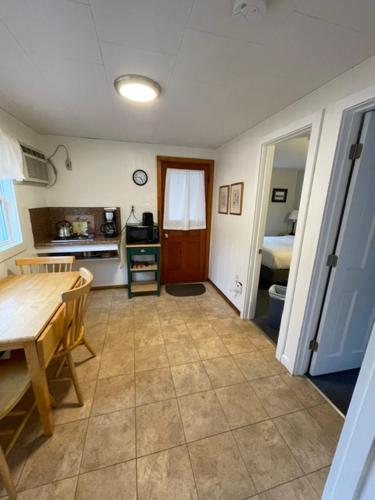 a kitchen with a table and a dining room at Elmwood Motor Court in Old Orchard Beach