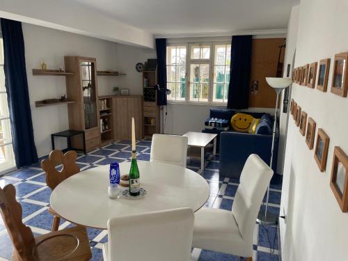 a living room with a table and chairs at Villa Vista Pannonia in Donnerskirchen