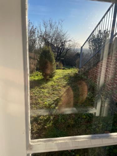 a view of a yard through a window at Villa Vista Pannonia in Donnerskirchen
