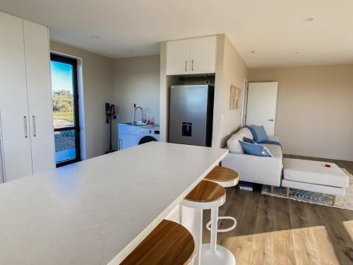 a kitchen and living room with a white counter top at Country Cottage in Sefton
