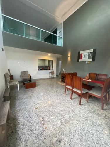a living room with a table and chairs at Casa pé na areia in Vila Velha