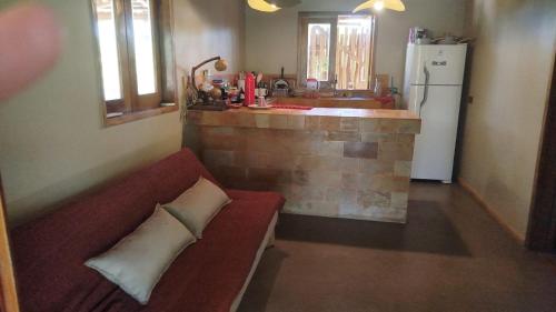 a living room with a couch and a kitchen at Casa Cariri- Preá in Prea