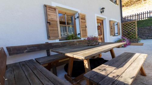 a wooden table and benches in front of a building at Spinuserhof in Tires