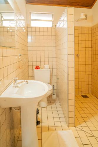 a bathroom with a sink and a toilet at Pousada Villa Tomasi in Jericoacoara