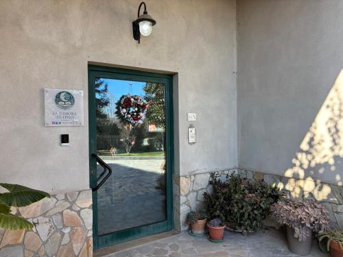 a door to a building with plants and a light at La dimora di Ipno in Vallata