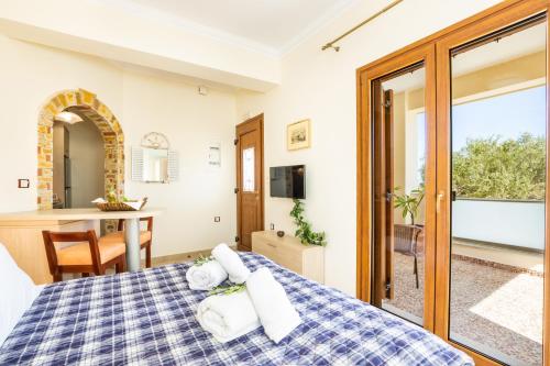 a bedroom with a bed with towels on it at Olive Studios Karpathos Studio #1 in Karpathos Town