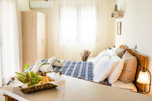 a table with a tray of vegetables on a bed at Olive Studios Karpathos Studio #1 in Karpathos Town