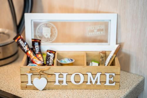 a wooden box with the words i home on a table at Olive Studios Karpathos Studio #1 in Karpathos Town
