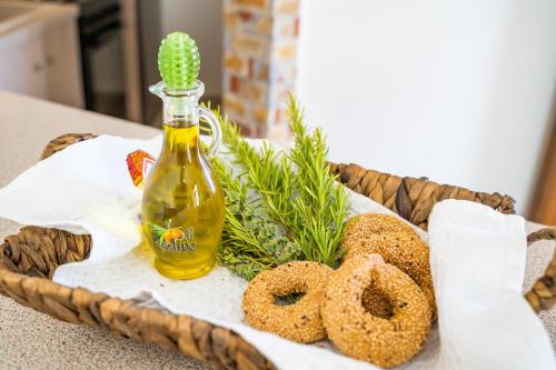 a basket with a bottle of oil and some bagels at Olive Studios Karpathos Studio #1 in Karpathos Town