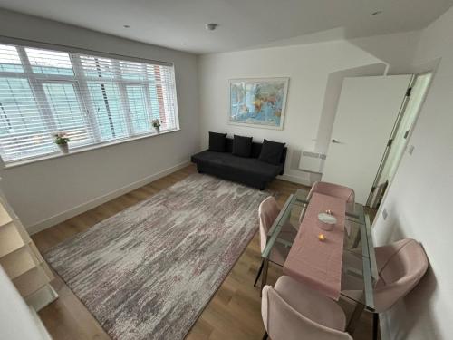 a living room with a glass table and a couch at Beatiful 3 bedroom apartment near Tower Bridge in London