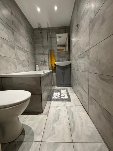 a bathroom with a tub and a toilet and a sink at Beatiful 3 bedroom apartment near Tower Bridge in London