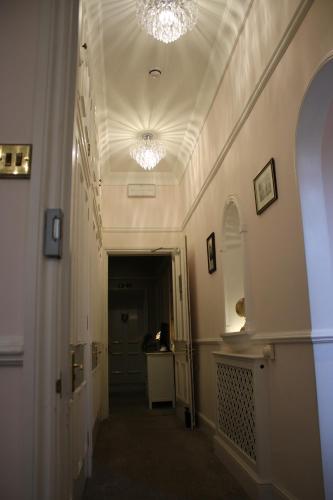 a hallway of a building with two lights on the ceiling at St Margaret's Hotel in Oxford