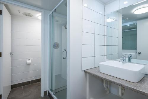 a bathroom with a sink and a shower at Admirals Motor Inn in Nelson