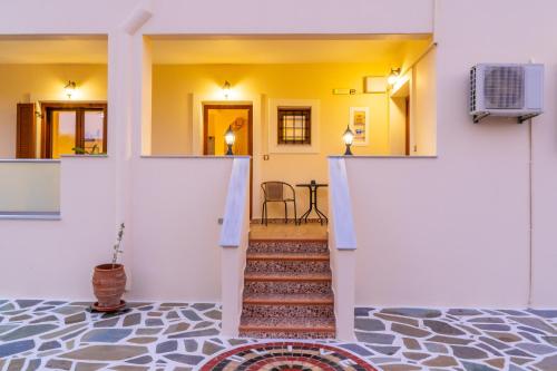 a hallway with a staircase in a house at Olive Studios Karpathos Studio #1 in Karpathos Town