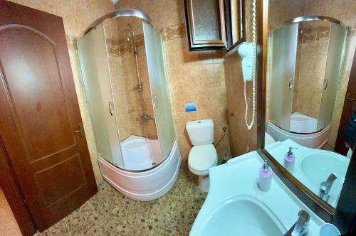 a bathroom with a sink and a shower and a toilet at Sea View Villa Paramonas in Paramonas