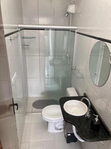 a bathroom with a shower and a toilet and a sink at Economize e aproveite a região ou descanse para o voo - 24h in Maceió