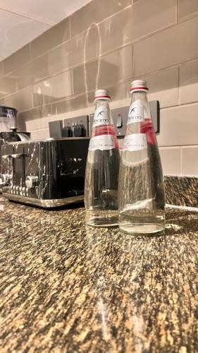 two bottles of water sitting on top of a counter at Luxury 1 bdrm Suite, Cantonments-Labone in Accra