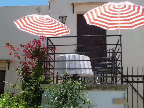 a balcony with two umbrellas on top of it at Calergi Residence - Holidays in Crete in Atsipopoulo