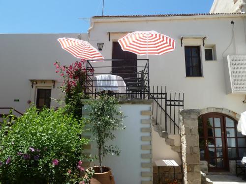 a staircase with umbrellas on top of a building at Calergi Residence - Holidays in Crete in Atsipopoulo