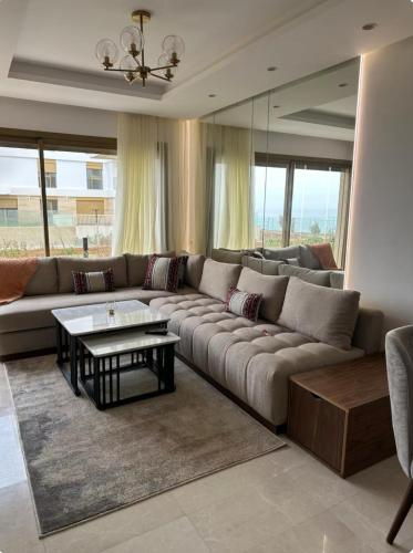 a living room with a couch and a table at La perle du carrousel in Rabat