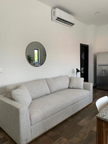 a living room with a couch and a mirror at Condominio Mar y Arena in Mazatlán