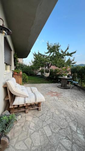 a patio with a white couch sitting on a patio at Il giardino di Chiara 1 Rifugio per anime stanche in Serrastretta