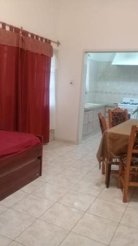 a living room with a table and a red curtain at Alojartur in San Rafael