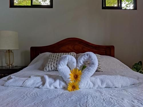 two swans made out of towels on a bed at Quinta 24 de Junio in Guácimo