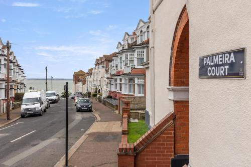a street with parked cars and a sign on a building at Modern 2 Bed Gem Southend on Sea Free parking in Southend-on-Sea