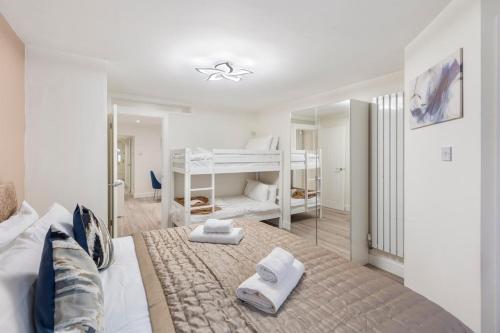 a bedroom with a bed with two bunk beds at Modern 2 Bed Gem Southend on Sea Free parking in Southend-on-Sea