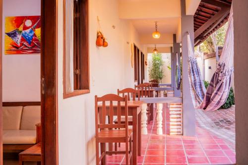 a room with a row of chairs and a table at Pousada Villa Tomasi in Jericoacoara