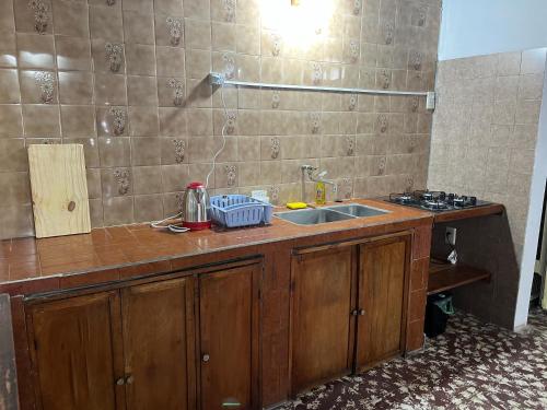 a kitchen with a sink and a counter top at Dulce Claudina 2 in Mercedes