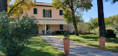 a large house with trees in the yard at Locanda Corte Roveri in Bologna