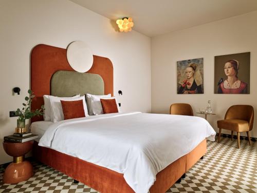 a bedroom with a large bed with a large headboard at Hotel Pietryna in Łódź