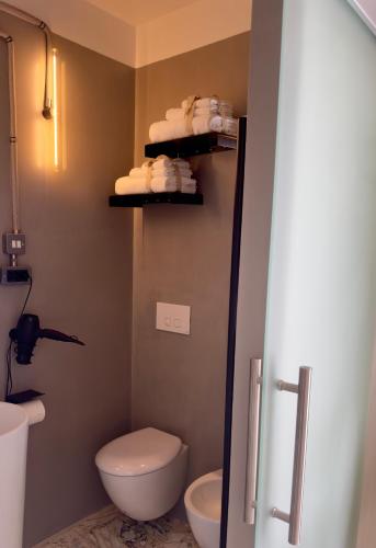 a bathroom with a toilet and a sink at HABITARE Lecce & Salento in Lecce