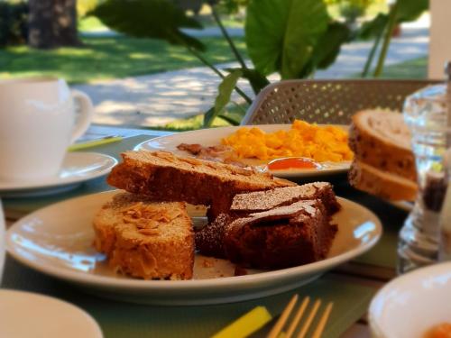 a plate of bread and toast on a table at Locanda Corte Roveri in Bologna