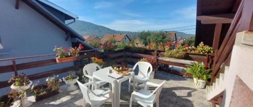 a patio with a table and chairs on a balcony at Jezero in Arandjelovac