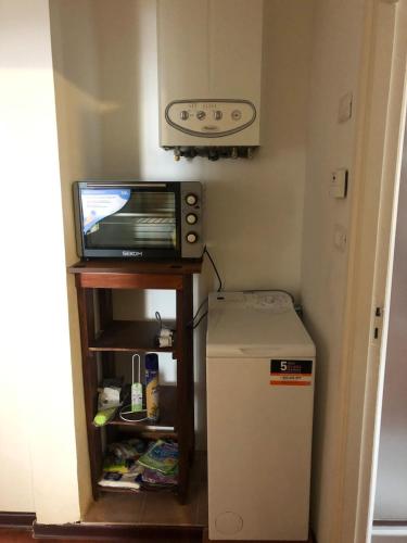 a small refrigerator and a television in a room at Giora House in Capracotta