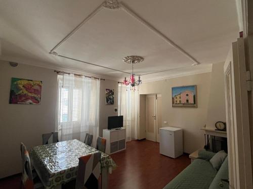 a dining room with a table and a television at Giora House in Capracotta