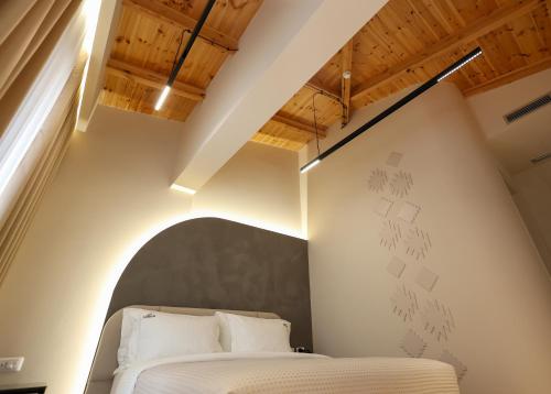 a bedroom with a bed in a room with wooden ceilings at Beratinus1 in Berat
